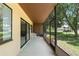 Screened-in lanai with outdoor seating area and views of the landscaped lawn at 501 Fairways Ln # A, Ocala, FL 34472