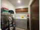 Functional laundry room featuring a washer, dryer, and storage shelves at 501 Fairways Ln # A, Ocala, FL 34472