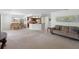 Open living room with neutral carpet, light colored walls and partial kitchen view at 501 Fairways Ln # A, Ocala, FL 34472