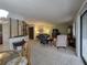 Open-concept living room with comfortable seating and lots of natural light at 501 Fairways Ln # A, Ocala, FL 34472