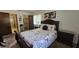 Bedroom featuring a floral comforter, dark wood furniture and ensuite bathroom at 501 Fairways Ln # A, Ocala, FL 34472