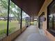 Relaxing screened-in patio area with views of the landscaped yard and buildings at 501 Fairways Ln # A, Ocala, FL 34472