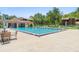 Community pool with a clubhouse surrounded by lounge chairs for relaxing in the sun at 501 Fairways Ln # A, Ocala, FL 34472