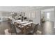 Dining room with modern table, seating for six, and seamless access to the kitchen with a breakfast bar at 5567 Nw 45Th Ln, Ocala, FL 34482