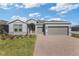 Charming single-Gathering home features a two-car garage and a brick-paved driveway at 5567 Nw 45Th Ln, Ocala, FL 34482