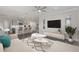 Open living room showcasing an modern sofa, stylish rug, and seamless transition to the well-equipped kitchen at 5567 Nw 45Th Ln, Ocala, FL 34482