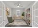 Bright home office with modern desk, ceiling fan, shelving unit, stylish decor, and neutral color palette at 5567 Nw 45Th Ln, Ocala, FL 34482
