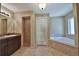 Bright bathroom featuring a soaking tub, walk-in shower, and vanity at 5590 Sw 172Nd Loop, Ocala, FL 34473