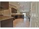 Well-lit kitchen with dark wood cabinets and countertops overlooks the dining and living area at 5590 Sw 172Nd Loop, Ocala, FL 34473