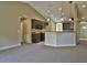 Open kitchen area with breakfast bar, pendant lights, and dark cabinetry at 5590 Sw 172Nd Loop, Ocala, FL 34473