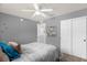 Cozy bedroom with ceiling fan, closet, and neutral decor offers a relaxing retreat at 5781 Sw 39Th St, Ocala, FL 34474