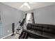 Relaxing bedroom features a comfortable black leather sofa and ceiling fan at 5781 Sw 39Th St, Ocala, FL 34474