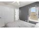 This bedroom offers a ceiling fan, window with blinds, and a spacious closet for storage at 5781 Sw 39Th St, Ocala, FL 34474