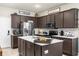 Modern kitchen features stainless steel appliances, a center island, and ample cabinet space at 5781 Sw 39Th St, Ocala, FL 34474