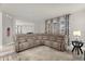 Open-concept living room featuring a large sectional sofa, neutral tones, and a view into the kitchen at 5781 Sw 39Th St, Ocala, FL 34474