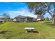 Expansive back yard with bench, landscaping and covered patio at 5877 Sw 103Rd St, Ocala, FL 34476