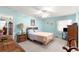 Serene bedroom featuring soft blue walls, plush carpeting, and ample natural light at 5877 Sw 103Rd St, Ocala, FL 34476