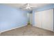 This bedroom has a ceiling fan, carpet, and large closet at 5877 Sw 103Rd St, Ocala, FL 34476