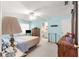 Tranquil bedroom with a ceiling fan, ensuite bathroom, and comfortable furnishings at 5877 Sw 103Rd St, Ocala, FL 34476