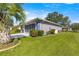 The house has a very well maintained lawn and is next to a palm tree at 5877 Sw 103Rd St, Ocala, FL 34476