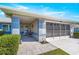 Charming front exterior with covered porch, tiled flooring, and a well-maintained two-car garage at 5877 Sw 103Rd St, Ocala, FL 34476