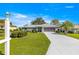 Charming single-story home with well-manicured lawn and screened garage at 5877 Sw 103Rd St, Ocala, FL 34476