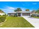 Charming single-story home with well-manicured lawn and screened garage at 5877 Sw 103Rd St, Ocala, FL 34476