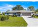 This home has a manicured lawn, and a long driveway at 5877 Sw 103Rd St, Ocala, FL 34476