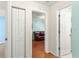 Hallway with doors leading to other rooms, including a living room at 5877 Sw 103Rd St, Ocala, FL 34476