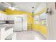 Bright kitchen with yellow walls, white appliances, and ample natural light at 5877 Sw 103Rd St, Ocala, FL 34476