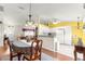 Open concept kitchen and dining area featuring wood floors, and a breakfast bar at 5877 Sw 103Rd St, Ocala, FL 34476