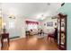 Open living room with laminate floors, floral sofas, and natural light at 5877 Sw 103Rd St, Ocala, FL 34476