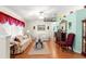 Cozy living room features laminate floors, floral sofas, and an electric fireplace at 5877 Sw 103Rd St, Ocala, FL 34476