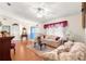 Living room featuring hardwood floors, ceiling fan, and a view of the entry at 5877 Sw 103Rd St, Ocala, FL 34476