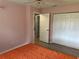 Bedroom with wood-look floors, closet, door frame to another room, and neutral wall paint at 6082 Sw 104Th St, Ocala, FL 34476