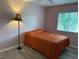 Cozy bedroom with a single bed and a lamp, window with blinds and pink walls at 6082 Sw 104Th St, Ocala, FL 34476