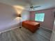 Bedroom featuring a single bed, ceiling fan, a lamp, window with blinds and pink walls at 6082 Sw 104Th St, Ocala, FL 34476