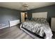 Comfortable bedroom featuring a ceiling fan, grey walls, and decorative white dressers at 6082 Sw 104Th St, Ocala, FL 34476