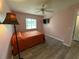 Bedroom featuring a single bed, TV, window with blinds, closet and pink walls at 6082 Sw 104Th St, Ocala, FL 34476
