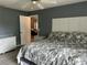 Bedroom with ceiling fan, white dresser, and view into another room at 6082 Sw 104Th St, Ocala, FL 34476