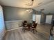 The dining area showcases modern lighting, unique wall paneling, and an open concept at 6082 Sw 104Th St, Ocala, FL 34476