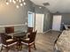 A dining area features unique wall designs, modern light fixture and an entrance at 6082 Sw 104Th St, Ocala, FL 34476