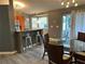 An open dining area features a glass table and views of the sliding glass doors at 6082 Sw 104Th St, Ocala, FL 34476