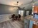 This well-lit dining area includes a table with chairs and offers a view of the kitchen and entrance at 6082 Sw 104Th St, Ocala, FL 34476