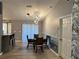 Open dining area with stylish light fixture, wainscoting, and easy access to the front door at 6082 Sw 104Th St, Ocala, FL 34476