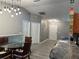 Open dining area with stylish light fixture, wainscoting, and easy access to the front door at 6082 Sw 104Th St, Ocala, FL 34476