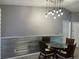 View of dining area with stylish chairs, modern light fixture, and wainscoting at 6082 Sw 104Th St, Ocala, FL 34476