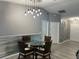 Open dining area with stylish light fixture, wainscoting, and easy access to the front door at 6082 Sw 104Th St, Ocala, FL 34476