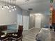 Open dining area with stylish light fixture, wainscoting, and easy access to the front door at 6082 Sw 104Th St, Ocala, FL 34476