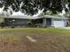 Charming single-story home with a two-car garage, manicured lawn, and colorful flowerbeds at 6082 Sw 104Th St, Ocala, FL 34476